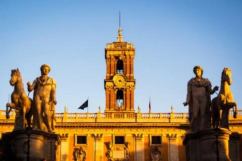 Passage between the equestrian statues of the Cordonata capitolina at sunset Stock Photos