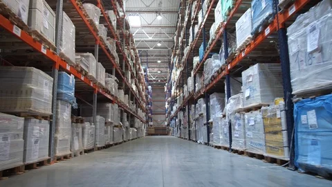 The passage of the camera along the high racks. Shelves are filled with boxes of Stock-Footage 111766609
