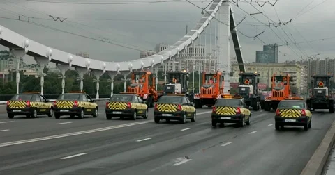 Passage of column of front loaders, parade of city vehicles Stock Footage 67506531