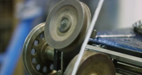 The passage of a flat cable through a rotating mechanism in the workshop for the Stock Footage 194948578