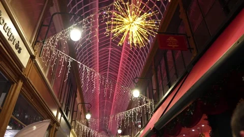 Passage Jouffroy in Paris on Dec 2 2023 with glass roof lit by Christmas lights Stock Footage 314891961