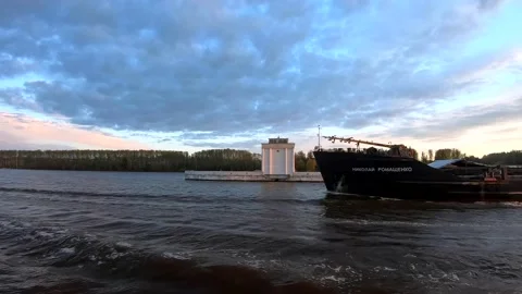 The passage of a large cargo ship along the river at sunset Video stock 153827846
