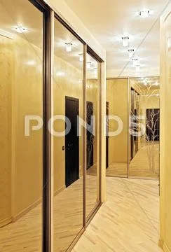 Passage with a mirror wardrobe in warm tones Stock Photos