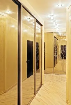 Passage with a mirror wardrobe in warm tones Stock Photos