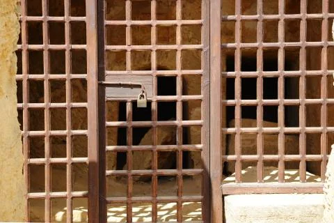 The passage in the old cave, closed bars with lock Stock-Fotos