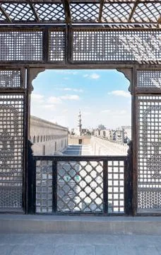 Passage surrounding the Mosque of Ibn Tulun framed by interleaved wooden p... Stock Photos
