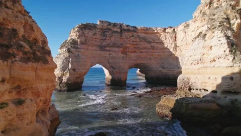 Passage through the arc Praia da Marinha Stock Footage 239978150