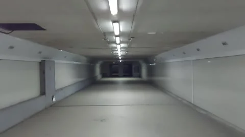 A passage through a long, dark corridor with lamps Video stock 264552097