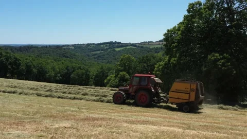 Passage of a tractor making round ballers Stock Footage 144484216