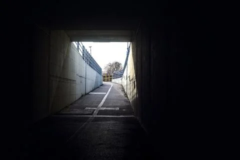 Passageway under a highway on a cloudy day Stock Photos