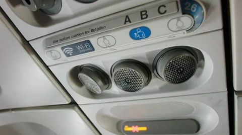 Passanger Turning on a Reading Light in an Airplane Stock Footage 64543705