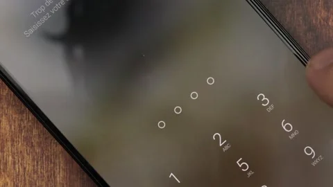 Passcode entry concept. Close-up of a finger entering the passcode of a smartpho Video stock 297481903