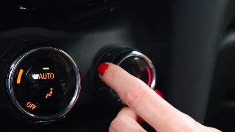 The passenger adjusts the temperature of the climate control in the car Stock Footage 302765035