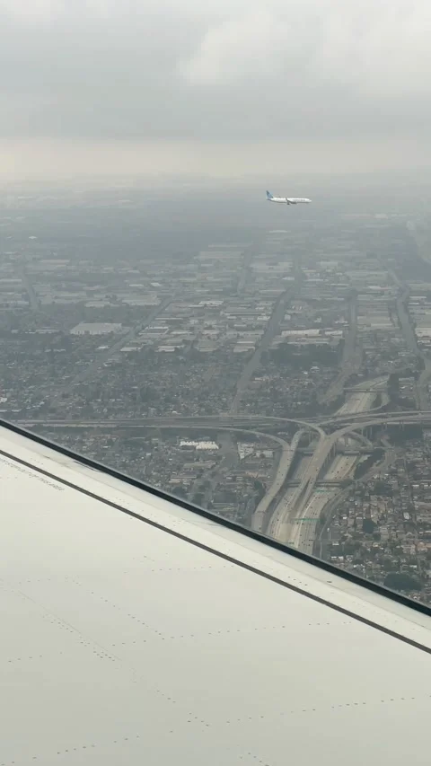 Passenger Aircraft flying parallel alongside over Los Angeles Stock Footage 318609617