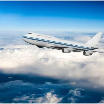 Passenger airplane in the clouds Stock Photos
