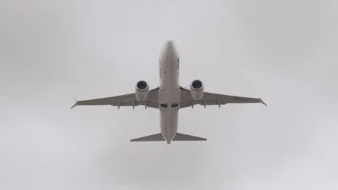Passenger airplane in cloudy sky. Unrecognizable aircraft overhead bottom view Stock Footage 279080689