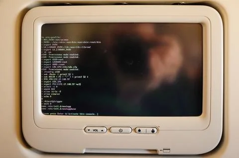 Passenger airplane console screen displaying Linux terminal. Фото