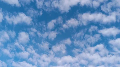 Passenger Airplane Flying Across a Blue Cloudy Sky Stock Footage 340238751