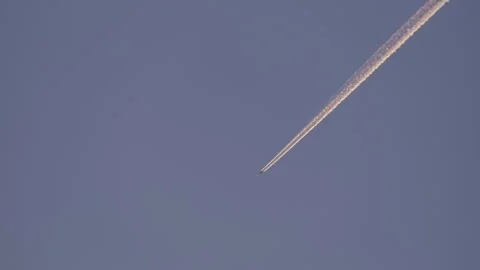 Passenger Airplane Flying Across Deep Blue Sky, Contrail, Clouds, Sunset Sunrise Stock Footage 241182552