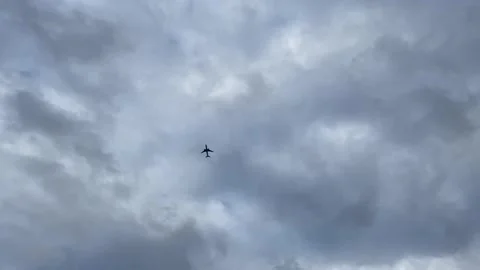 Passenger airplane flying among the clouds - Bottom view Stock Footage 151108012