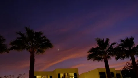 Passenger airplane flying at sunset over tropical palm trees against beauti.. Stock Footage 338332722