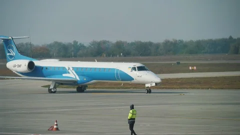 Passenger airplane is making a U-turn in an airfield in summer in slo-mo Stock-Footage 102273926