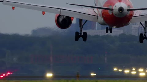 Passenger airplane performing a reverse thrust landing on runway Stock Footage 288692955