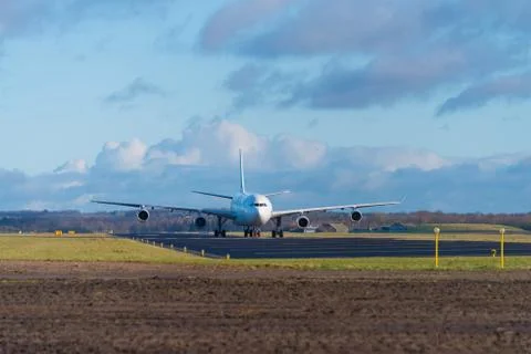 Passenger airplane on runway Stock Photos