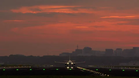 Passenger airplane soaring into the sky during a breathtaking sunset Stock Footage 288707433