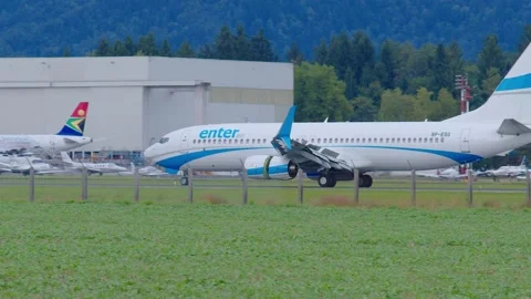 Passenger airplane SP-ESG Enter Air Boeing 737-800 taxiing towards the terminal Stock Footage 163534838