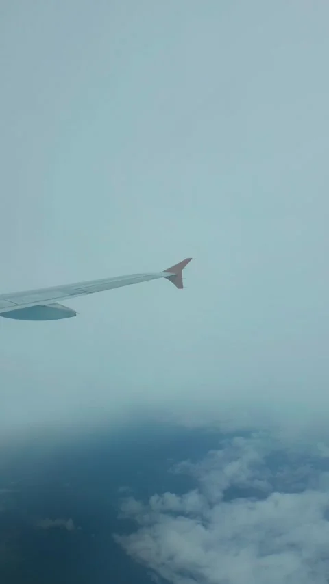 Passenger airplane wing view flying above fluffy clouds on a bright day jou.. Stock-Footage 333838995