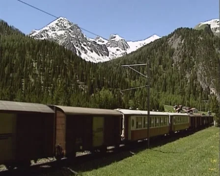 Passenger and freight train direction St.Moritz, Switzerland - tracking shot Stock Footage 43825936