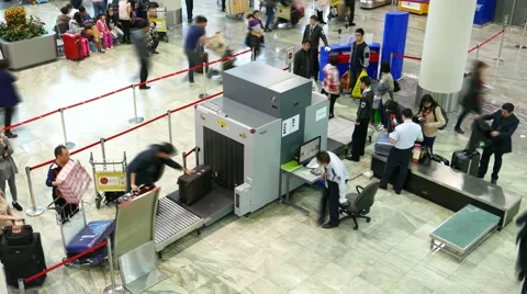 Passenger bag move through screening X-ray machine, time lapse shot Stock Footage 58508714