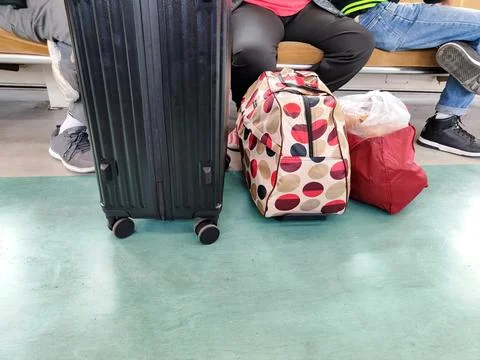 Passenger bags placed on the floor of the train Stock Photos