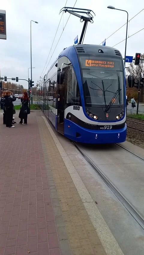Passenger blue tramway no. 4 running in Krakow arrives at stop. Stock Footage 292310346