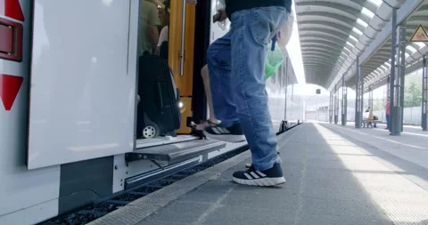 Passenger Boarding Double Deck Train With Suitcase, Sunlit Platform, Ground Shot Video stock 340673737