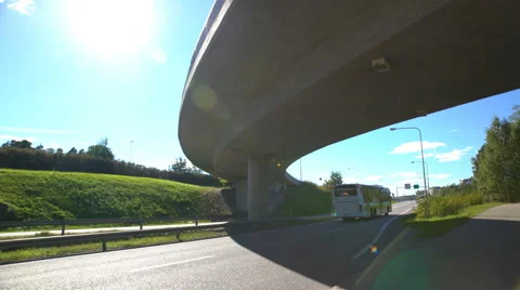 A passenger bus at a high speed rides on the highway under the bridge. Stock Footage