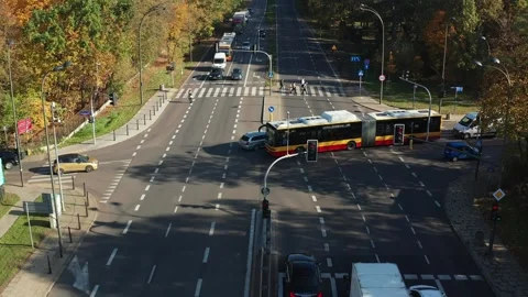 A passenger bus passes through an intersection with a traffic light Stock Footage 254338292