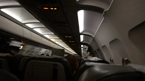 The passenger cabin of the plane in the evening. before takeoff Stock Footage 147686688