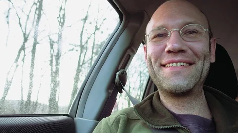 Passenger in the car looking forward and smiles Stock Footage 75419552