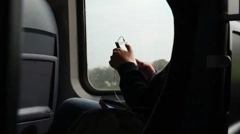 Passenger checking cell phone during a train ride Stock Footage 46156859