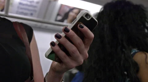 Passenger checking smartphone standing on crowded subway train - 4K Stock Footage 54504599