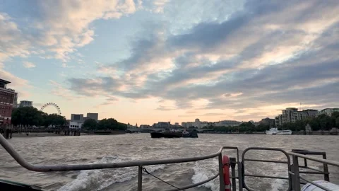 Passenger deck view of a working barge crossing choppy River Thames under a Stock Footage 342186217