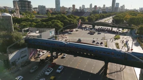 Passenger Electric Train Crossing Bridge Over Urban Road, Aerial Drone View Video stock 330100571