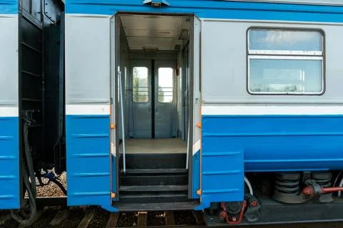 A passenger electric train is standing on the platform at the stop. Empty car Stock Photos