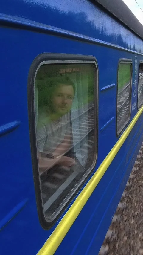 Passenger Enjoying the Views and Checking His Watch on a Moving Train Stock Footage 285846770