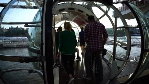 Passenger enter capsule cabin pod of London Eye (Millennium Wheel) ferris wheel. Stock Footage 116679758