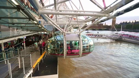 Passenger enter capsule cabin pod of London Eye (Millennium Wheel) ferris wheel. Stock Footage 252783405