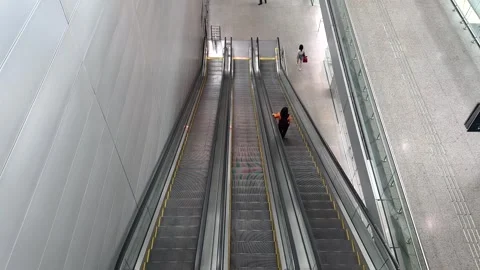 Passenger escalator going up. Escalators operating in empty airport terminal Stock Footage 305058465