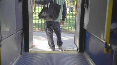 Passenger Exiting a City Bus Through Rear Doors Stock Footage 332688873